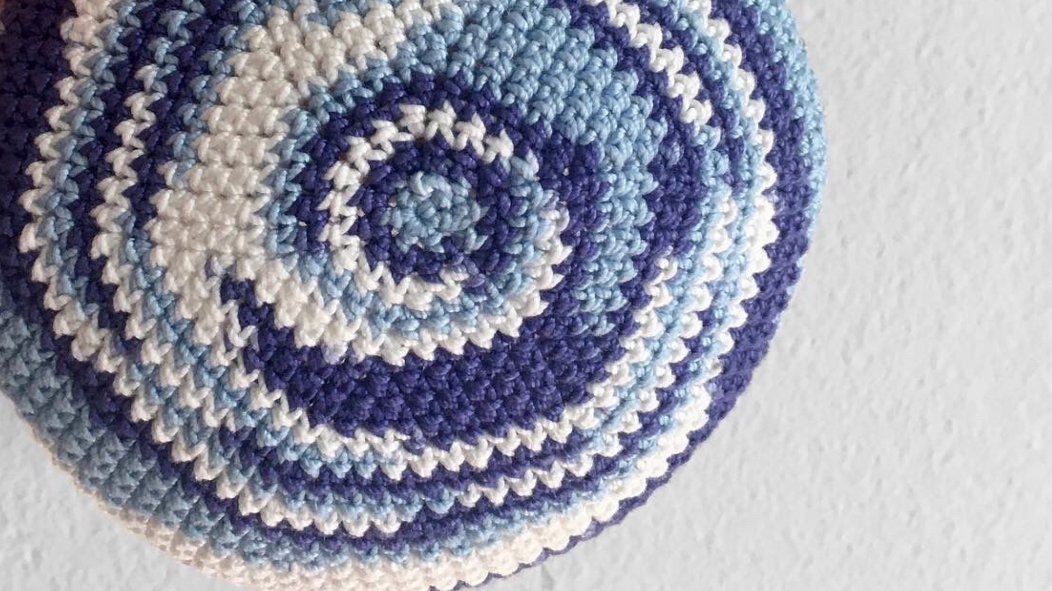 Close up of the Penelope D Thin Kippah in variegated blue 